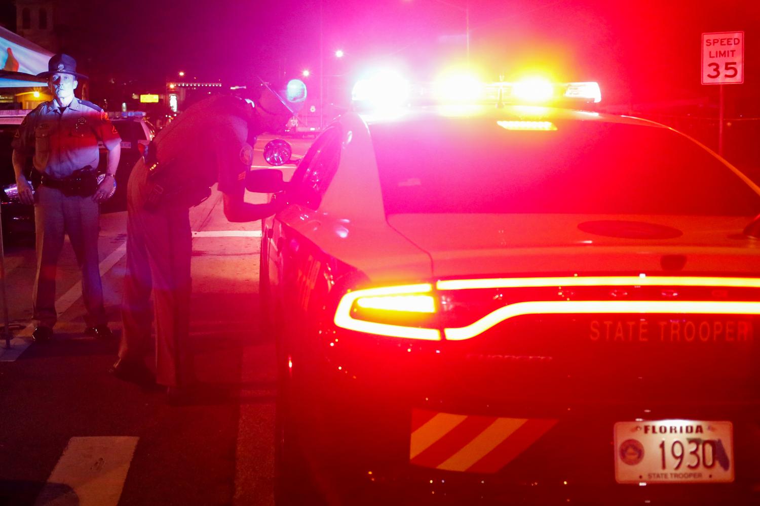 Florida State Troopers cordon off an intersection.