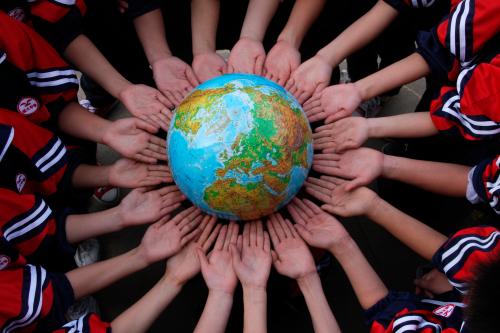 Students pose for the photo with a globe during a campaign to mark the World Earth Day in a middle school in Dexing, Jiangxi province April 19, 2011. The World Earth Day falls on April 22 every year. Picture taken April 19, 2011. REUTERS/China Daily (CHINA)   BEST QUALITY AVAILABLE