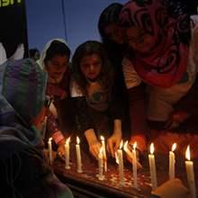 REUTERS/Mohsin Raza - Members of a civil society light candles for peace against terrorist attacks in the country in Lahore February 12, 2014.