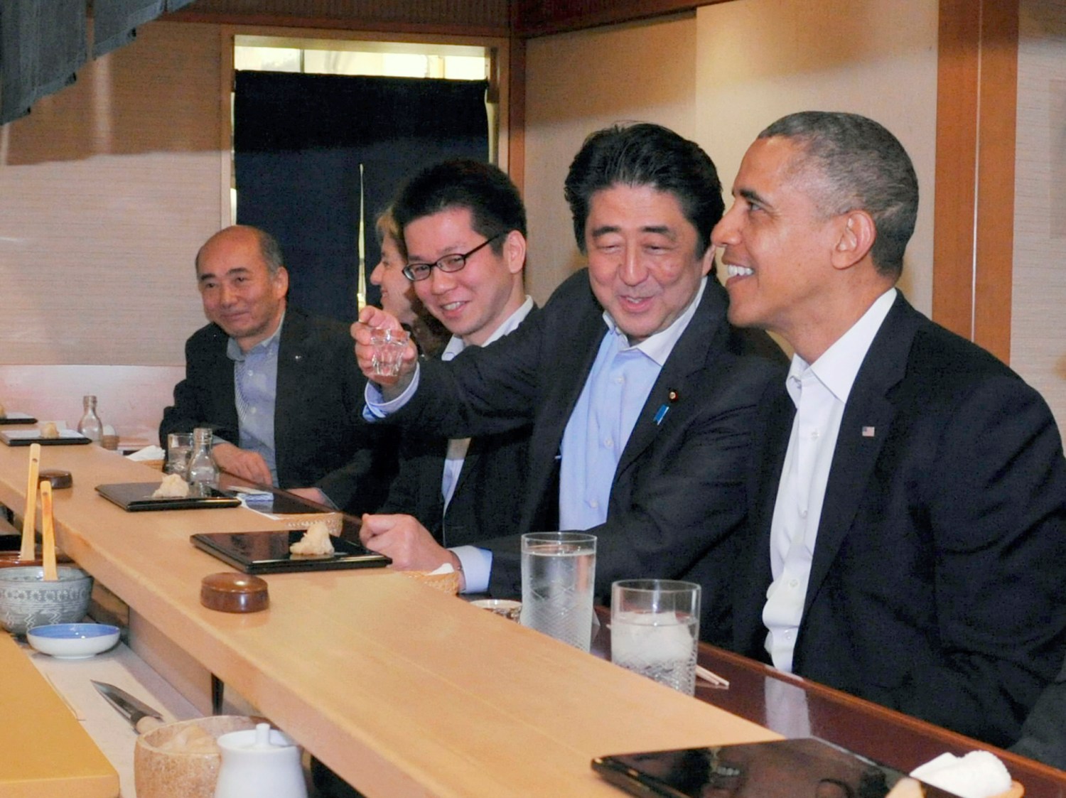 Reuters – Japanese Prime Minister Shinzo Abe (2nd R) shares a laugh with U.S. President Barack Obama (R) as they have dinner at the Sukiyabashi Jiro sushi restaurant in Tokyo, in this picture taken April 23, 2014.