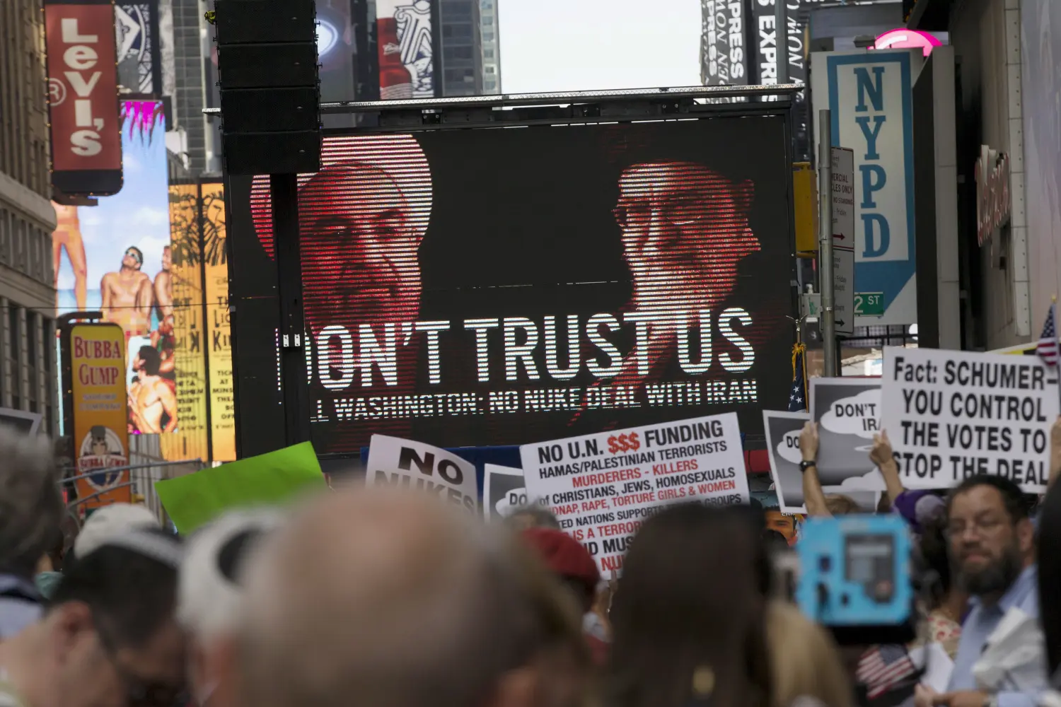 An image of Iranian leaders is projected on a giant screen in front of demonstrators during a rally apposing the nuclear deal with Iran in Times Square in the Manhattan borough of New York City, July 22, 2015. REUTERS/Mike Segar
