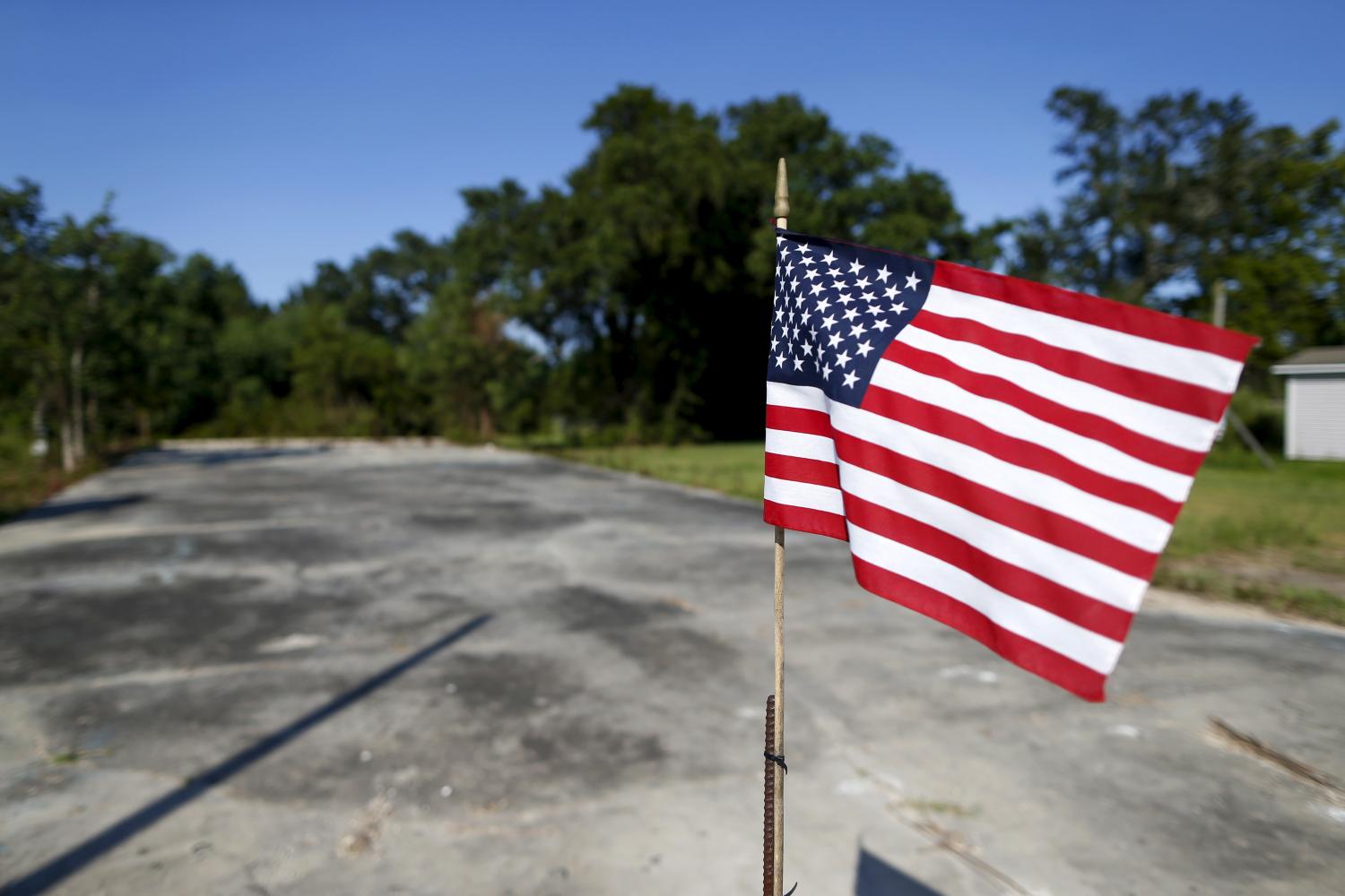 An American flag waves over an empty lot in Waveland, Mississippi