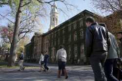 People walk past Princeton University's Nassau Hall in Princeton