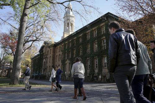 People walk past Princeton University's Nassau Hall in Princeton