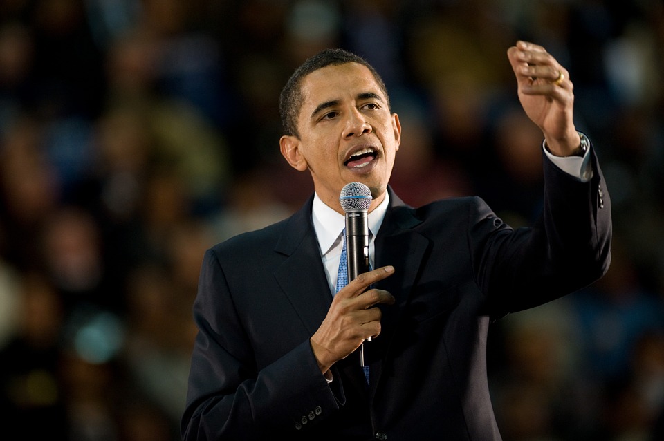 Barack Obama gestures while giving a speech.