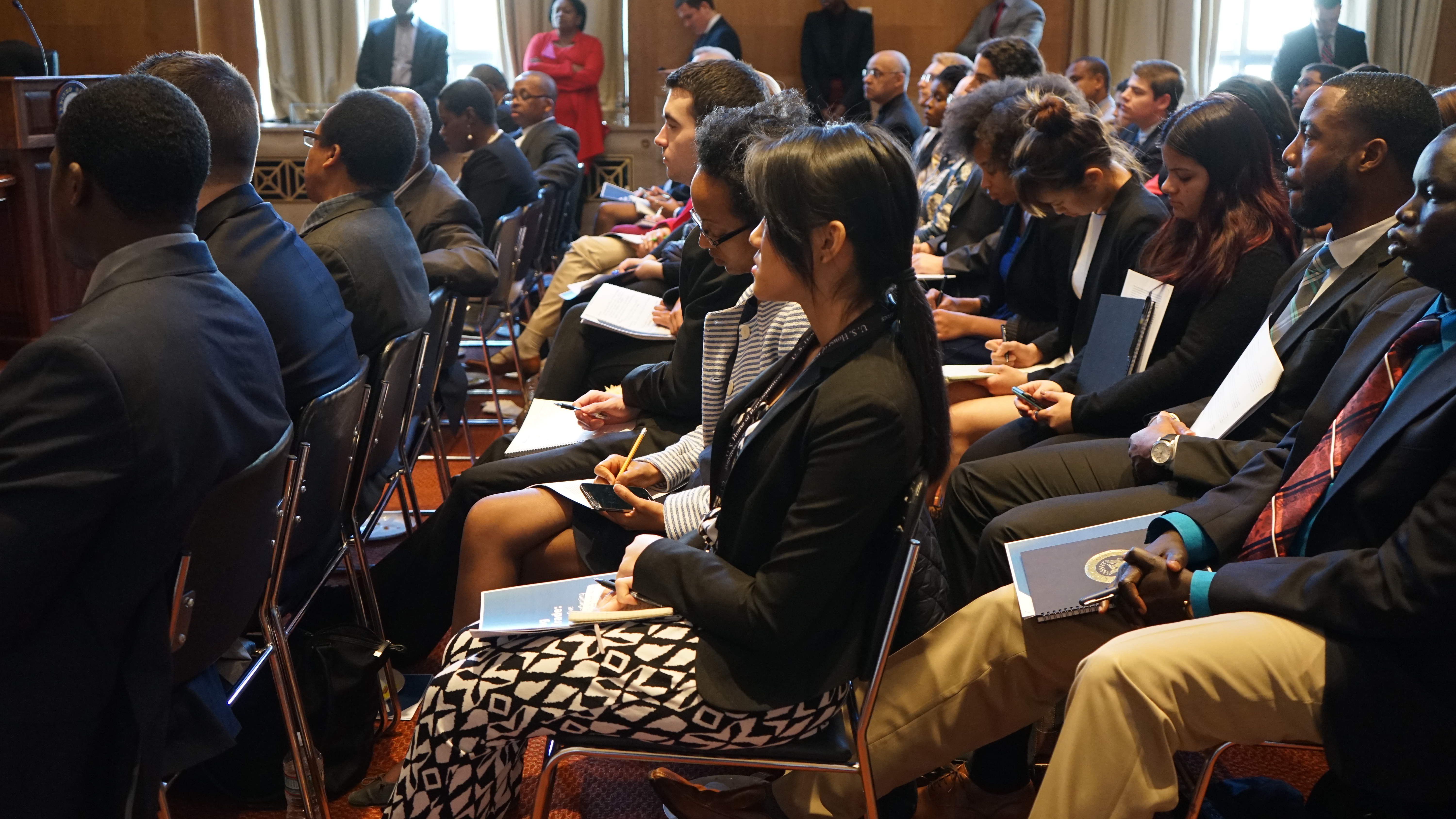 Audience members listen closely as Witney Schneidman highlights the potential for “AGOA strategies” to assist African countries in growing their exports.