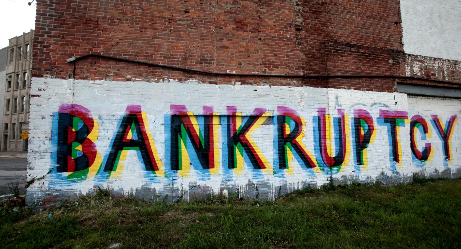 Bankruptcy graffiti on wall
