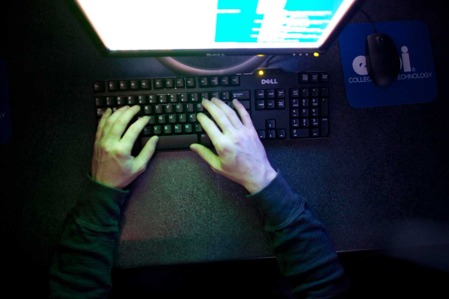 Hands typing on a computer