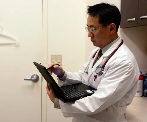 a doctor works on his laptop