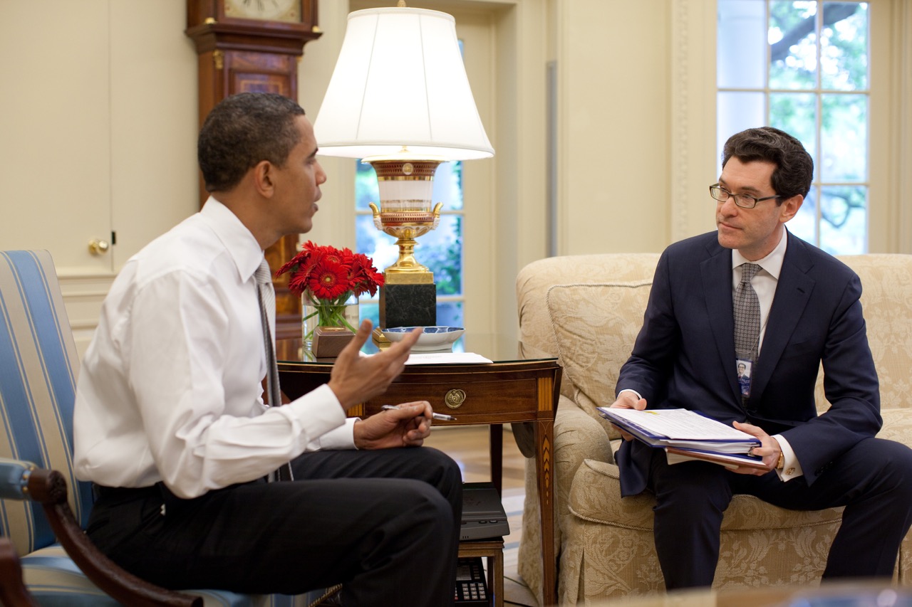 Barack Obama sits opposite Norman Eisen in the Oval Office seating area.