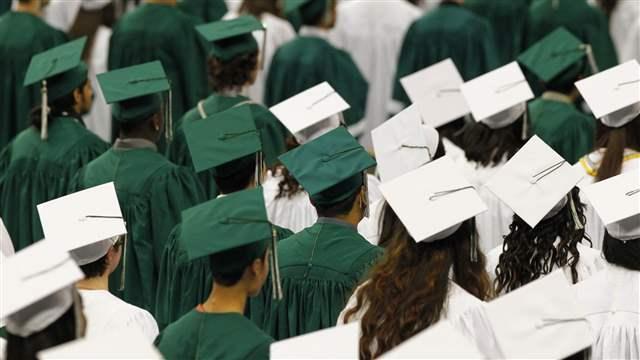 Reynolds High School students observe a moment of silence in memory of 14-year-old Emilio Hoffman, during their graduation ceremony at the Veterans Memorial Coliseum in Portland June 12, 2014 (REUTERS/Steve Dipaola).