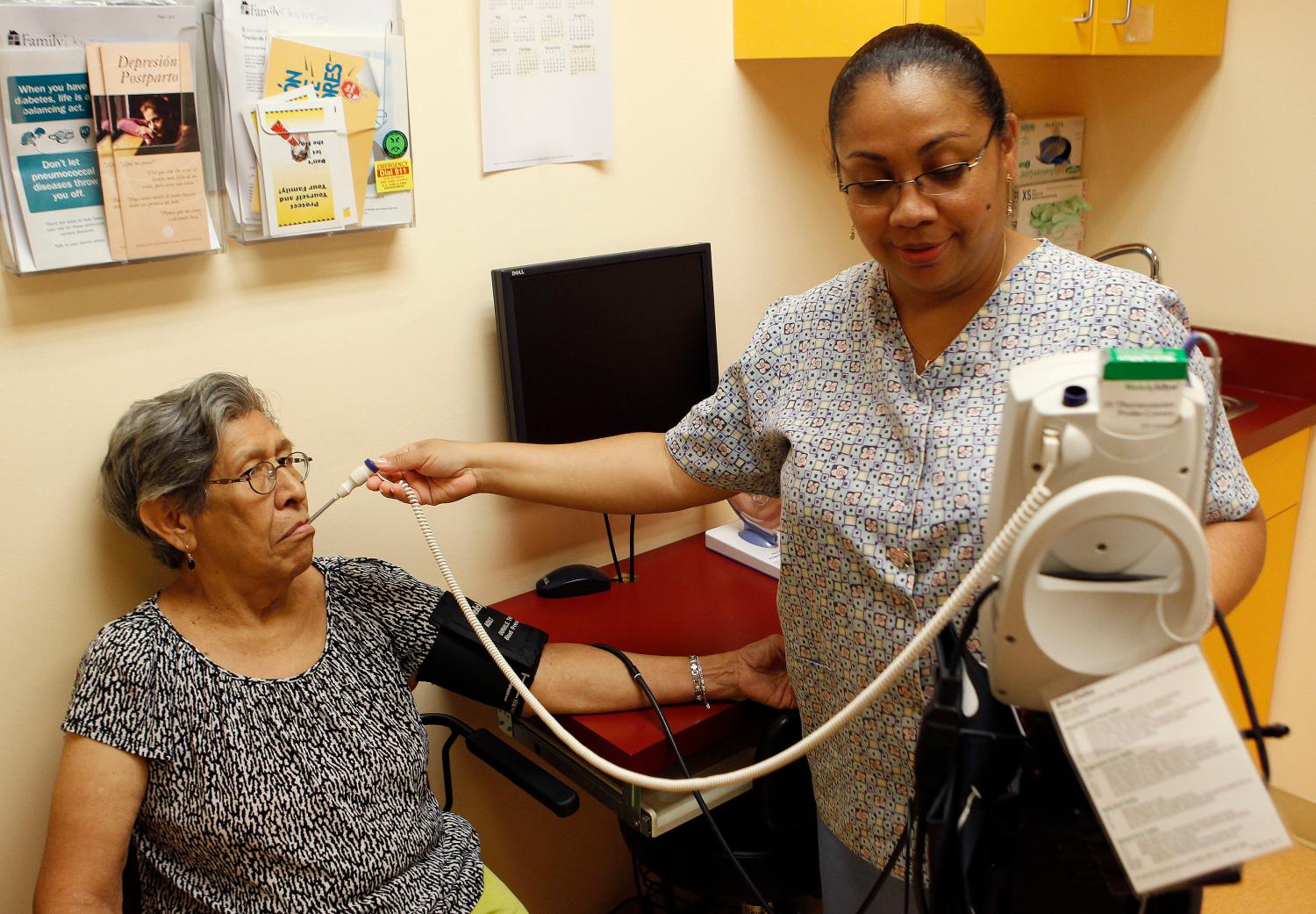 A woman gets her temperature taken