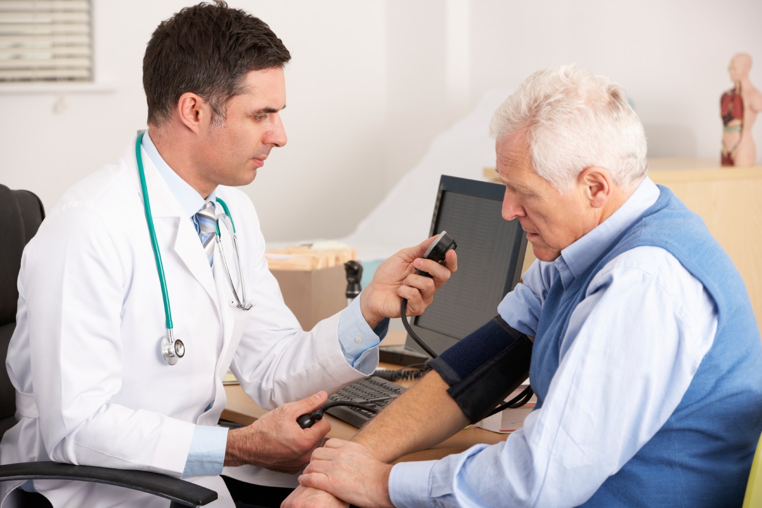 An elderly man gets his blood pressure taken