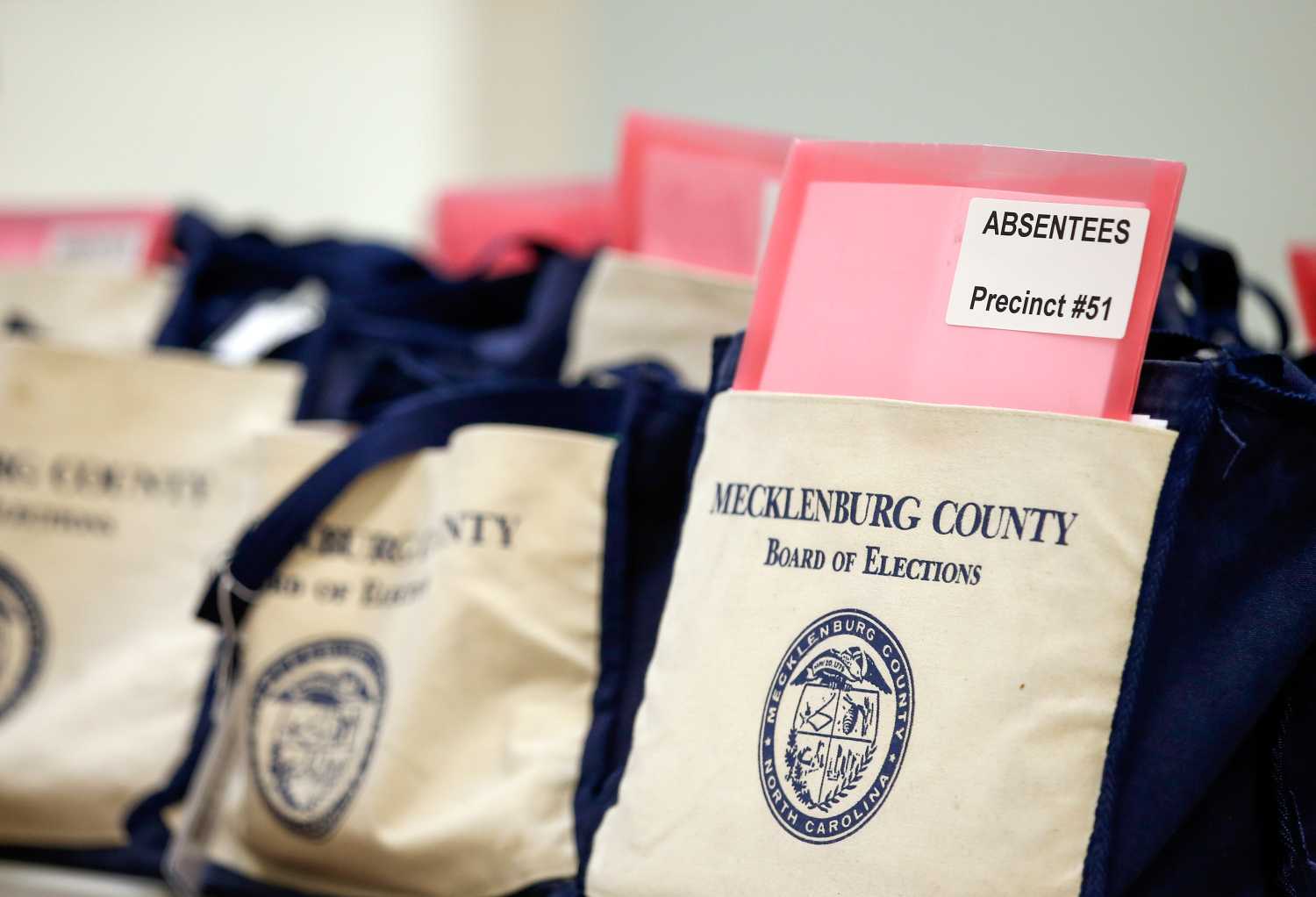 absentee ballots sit in bags waiting to be tallied.
