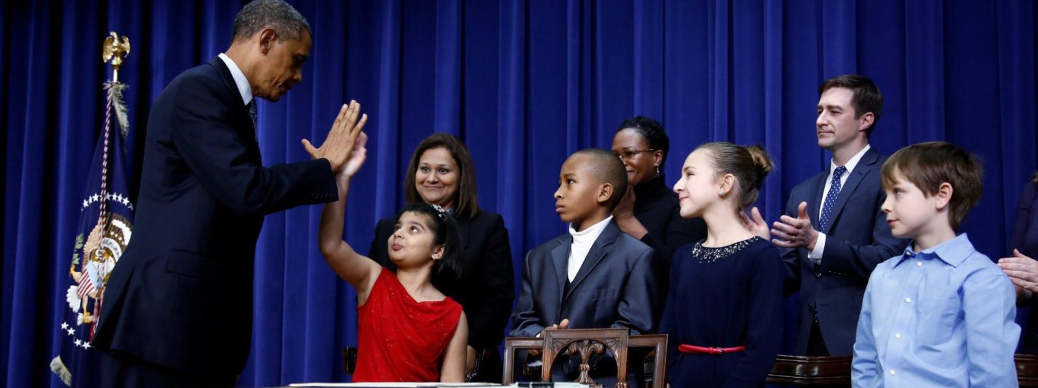 U.S. President Barack Obama high-fives eight-year-old Hinna Zejah after unveiling a series of gun control proposals during an event at the White House in Washington, January 16, 2013.