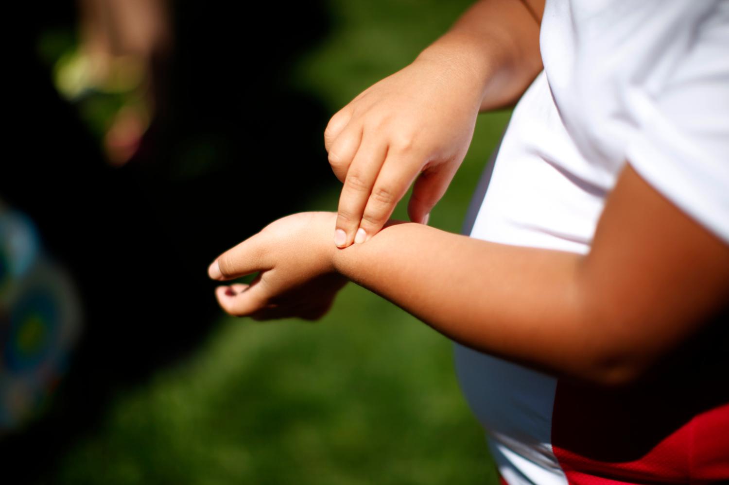 A child checks their pulse