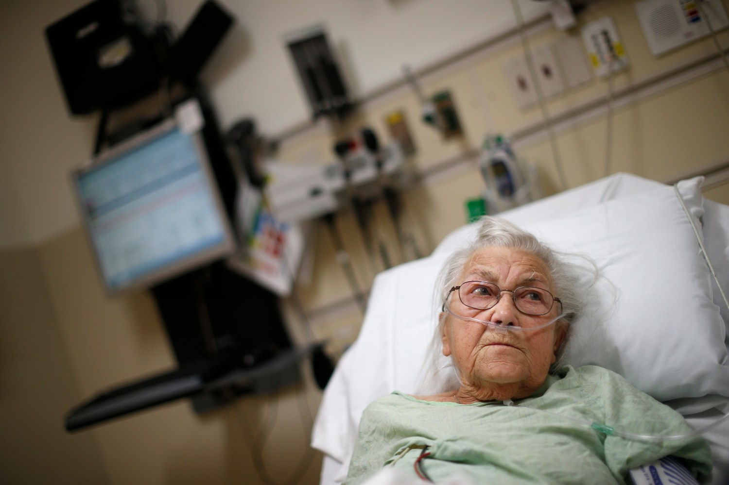 A woman lies in a hospital bed