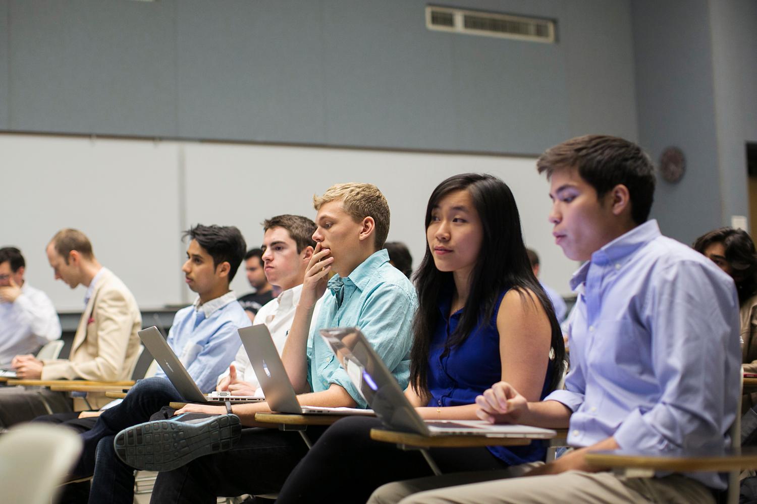 students attend a lecture with their laptops