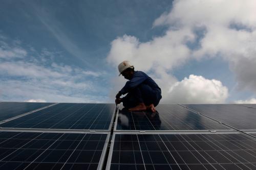 Worker installing solar panels