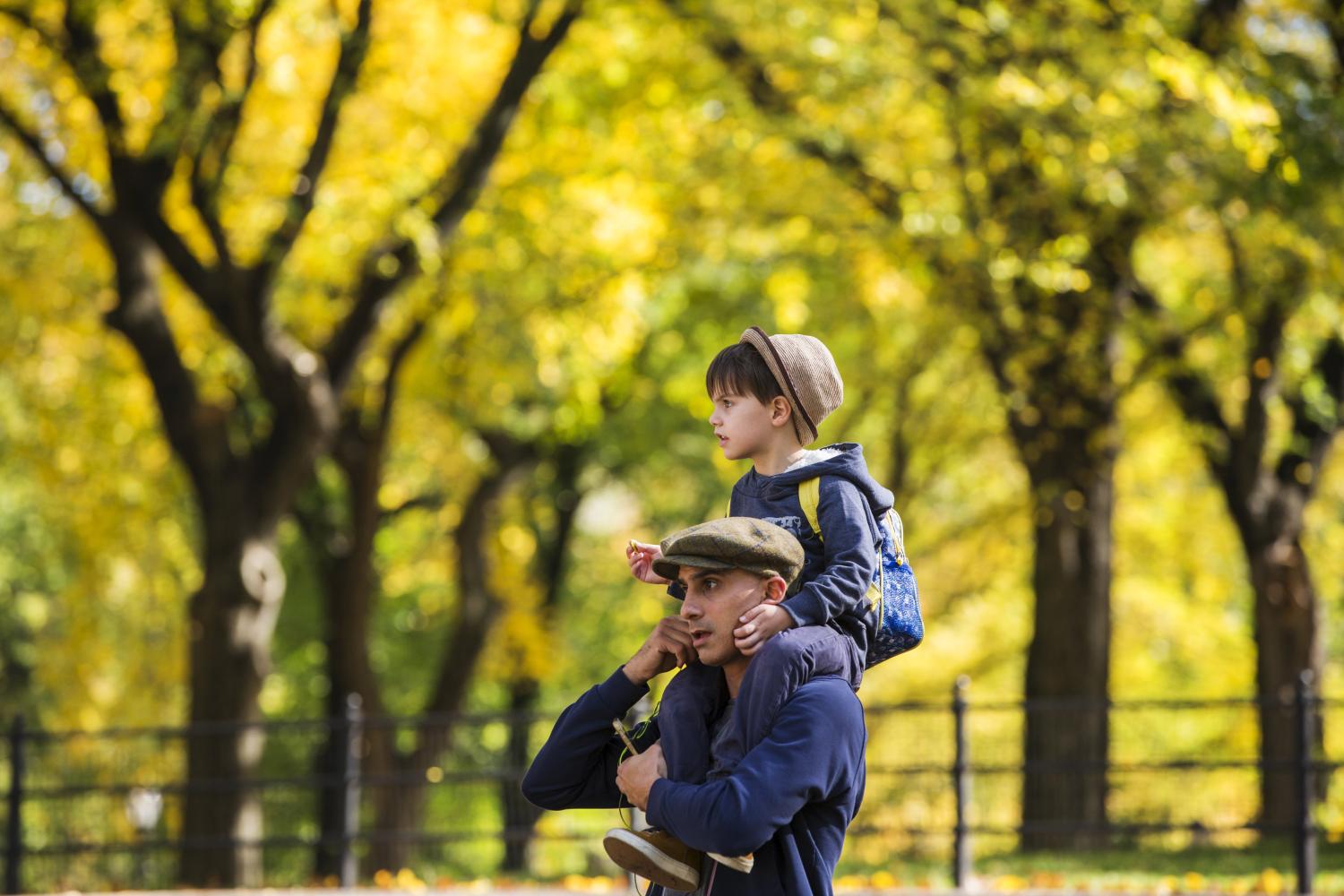 A man carries a young boy on his shoulders