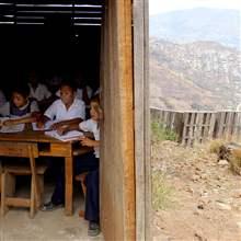 Honduran children attend a class at an outdoors makeshift school at a shantytown on the outskirts of Tegucigalpa.