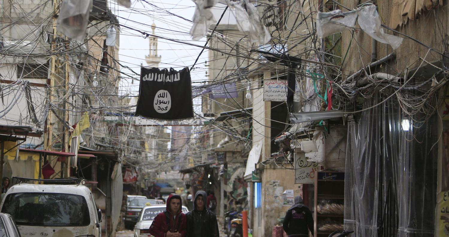 ISIS flag hangs overhead.