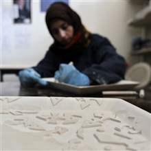 A Jordanian employee engraves a handcrafted ceramic salver at a Beit al Bawadi ceramics workshop in Amman January 7, 2014.