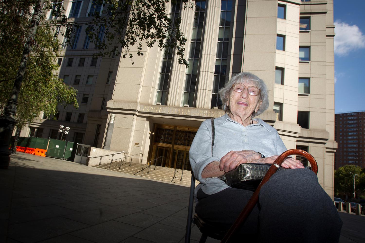 A woman sits on a bench.