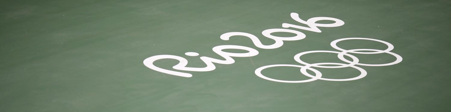 2016 Rio Olympics - Olympic Park - 29/07/2016. A worker walks across a tennis court in the Olympic Park. REUTERS/Nacho Doce - RTSKA83