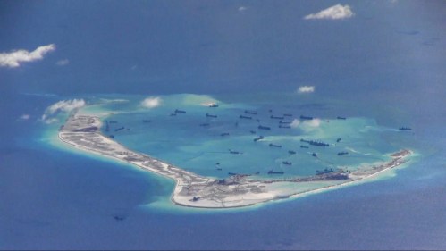 Chinese dredging vessels are purportedly seen in the waters around Mischief Reef in the disputed Spratly Islands in the South China Sea in this still image from video taken by a P-8A Poseidon surveillance aircraft provided by the United States Navy May 21, 2015. U.S. Navy/Handout via Reuters/File Photo