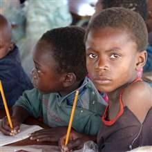 Zambian children attend school in a poverty stricken area near the country's capital Lusaka July 1, 2005.