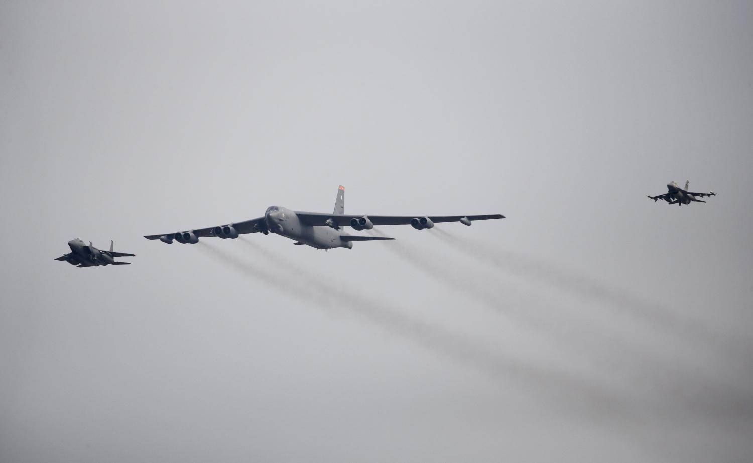 A U.S. Air Force B-52 (C) flies over Osan Air Base in Pyeongtaek, South Korea, January 10, 2016. REUTERS/Kim Hong-Ji - RTX21PNS