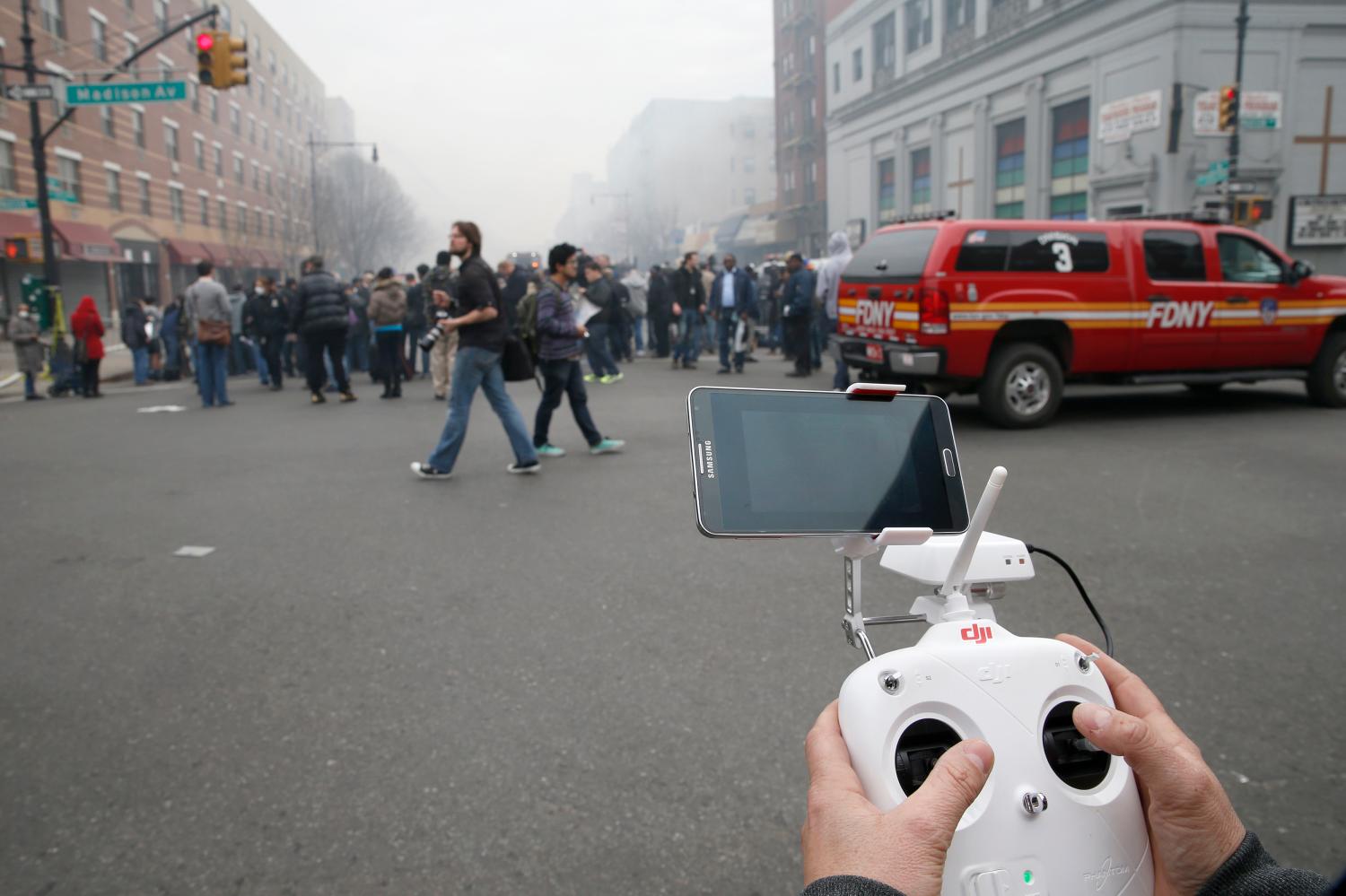 A camera drone flown by Brian Wilson flies near the scene where two buildings were destroyed in an explosion, in the East Harlem section in New York City, March 12, 2014. REUTERS/Mike Segar