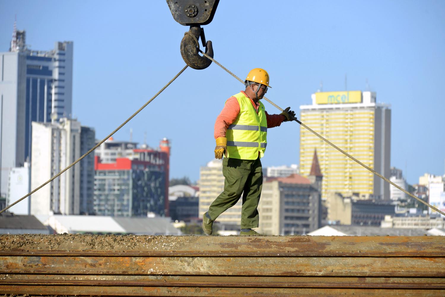 A Chinese construction worker helps build a new bridge against the skyline of Mozambique's capital Maputo April 15, 2016. REUTERS/Grant Lee Neuenburg - RTX2BG6I