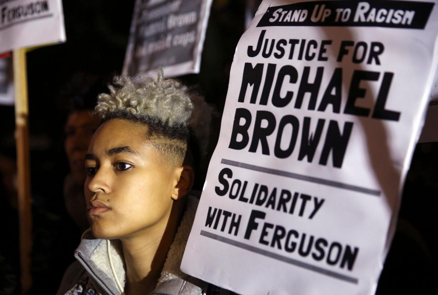 A demonstrator takes part in a protest to show solidarity with the family of black teenager Michael Brown.
