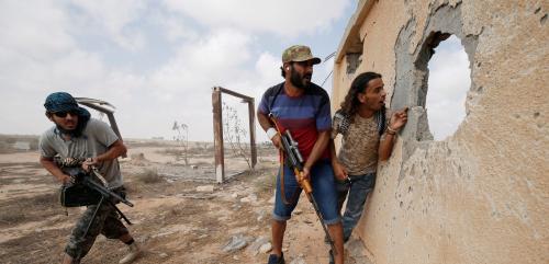 Libyan forces allied with the U.N.-backed government take cover during a battle with Islamic State fighters in Sirte, Libya, July 15, 2016. REUTERS/Goran Tomasevic/File Photo - RTSLTSD