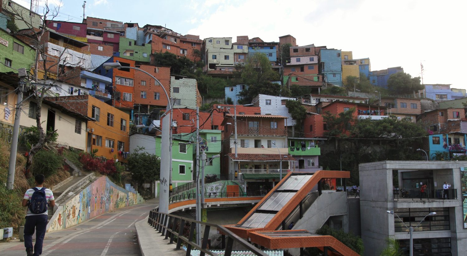 A man walks in the "Comuna 13" neighborhood in Medellin September 2, 2015. Picture taken September 2, 2015. To match DEVELOPMENT-GOALS/COLOMBIA-CITIES REUTERS/Fredy Builes - RTSE9A