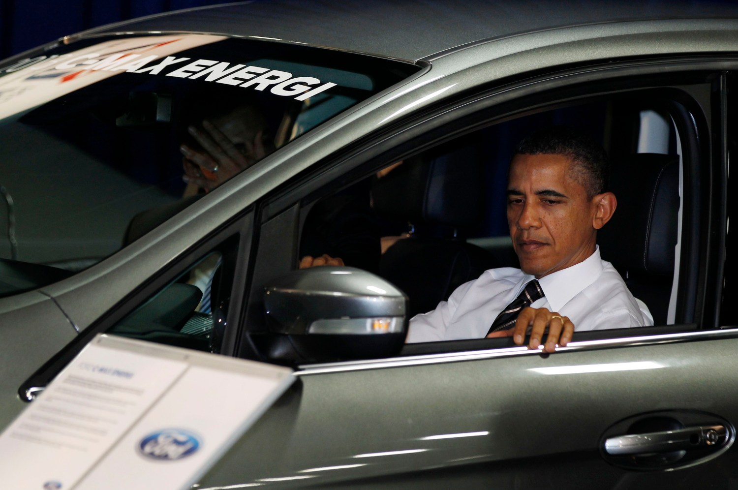 U.S. President Barack Obama sits inside a hybrid vehicle at the 2012 Washington Auto Show at the Walter E. Washington Convention Center in Washington, January 31, 2012.