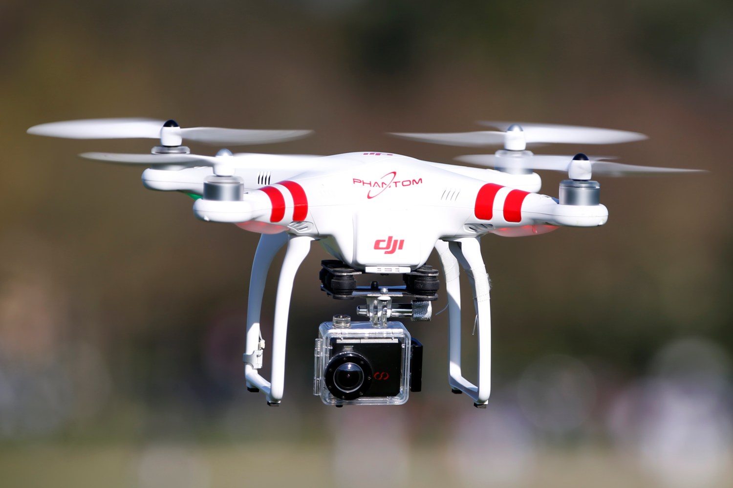 A Phantom drone by DJI company, equipped with a camera, flies during the 4th Intergalactic Meeting of Phantom's Pilots (MIPP) in an open secure area in the Bois de Boulogne, western Paris, March 16, 2014. REUTERS/Charles Platiau