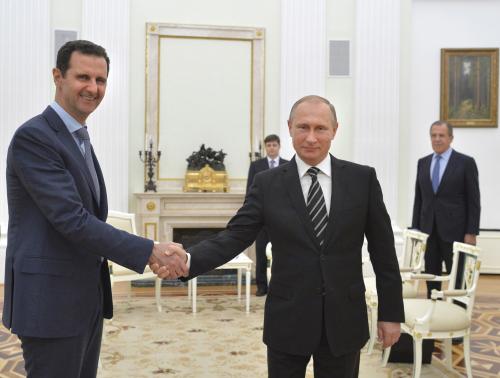 Russian President Vladimir Putin (R) shakes hands with Syrian President Bashar al-Assad during a meeting at the Kremlin in Moscow, Russia, in this October 20, 2015 file photo. To match Insight MIDEAST-CRISIS-SYRIA/PUTIN REUTERS/Alexei Druzhinin/RIA Novosti/Kremlin/ Files