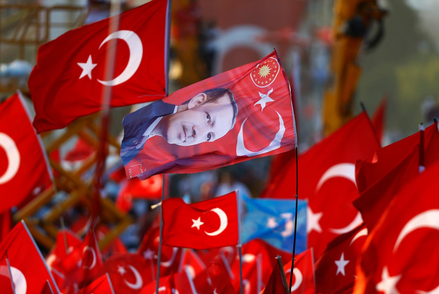 A flag with the picture of Turkey's President Tayyip Erdogan is seen during the Democracy and Martyrs Rally, organized by him and supported by ruling AK Party (AKP), oppositions Republican People's Party (CHP) and Nationalist Movement Party (MHP), to protest against last month's failed military coup attempt, in Istanbul, Turkey, August 7, 2016. REUTERS/Osman Orsal