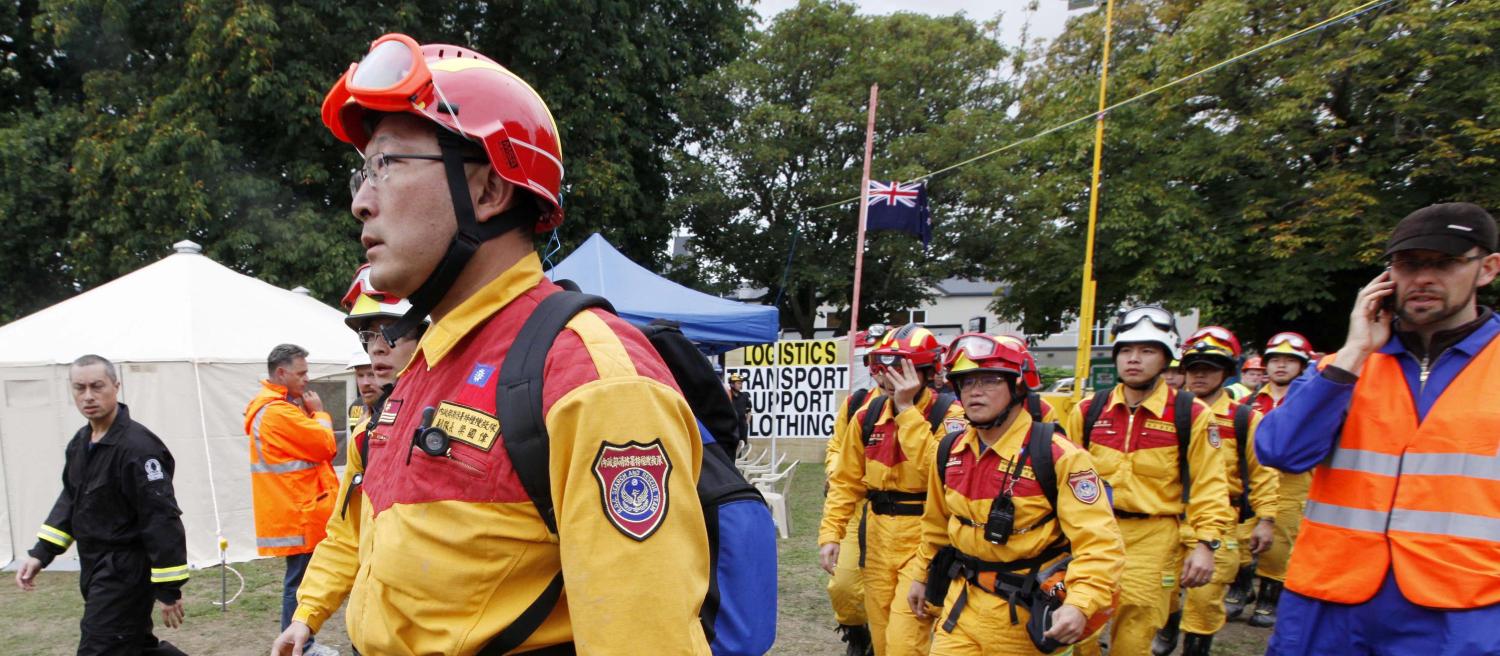 Relief workers from Taiwan walk though a tent city in central Christchurch, home to relief workers following Tuesday's earthquake February 26, 2011.