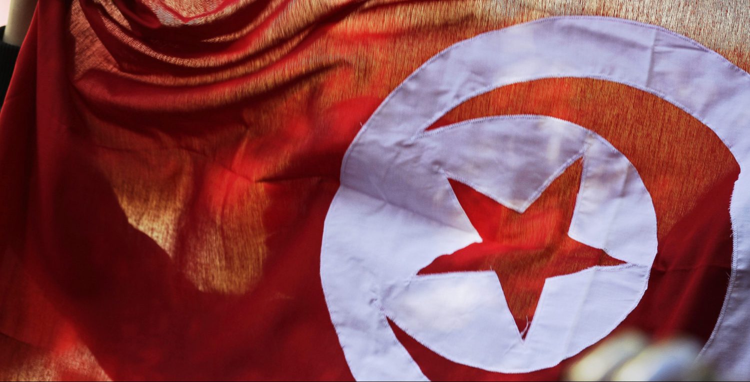 A person holds up a Tunisian flag and shouts slogans during celebrations marking the fourth anniversary of Tunisia's 2011 revolution, in Habib Bourguiba Avenue in Tunis January 14, 2015. REUTERS/Anis Mili