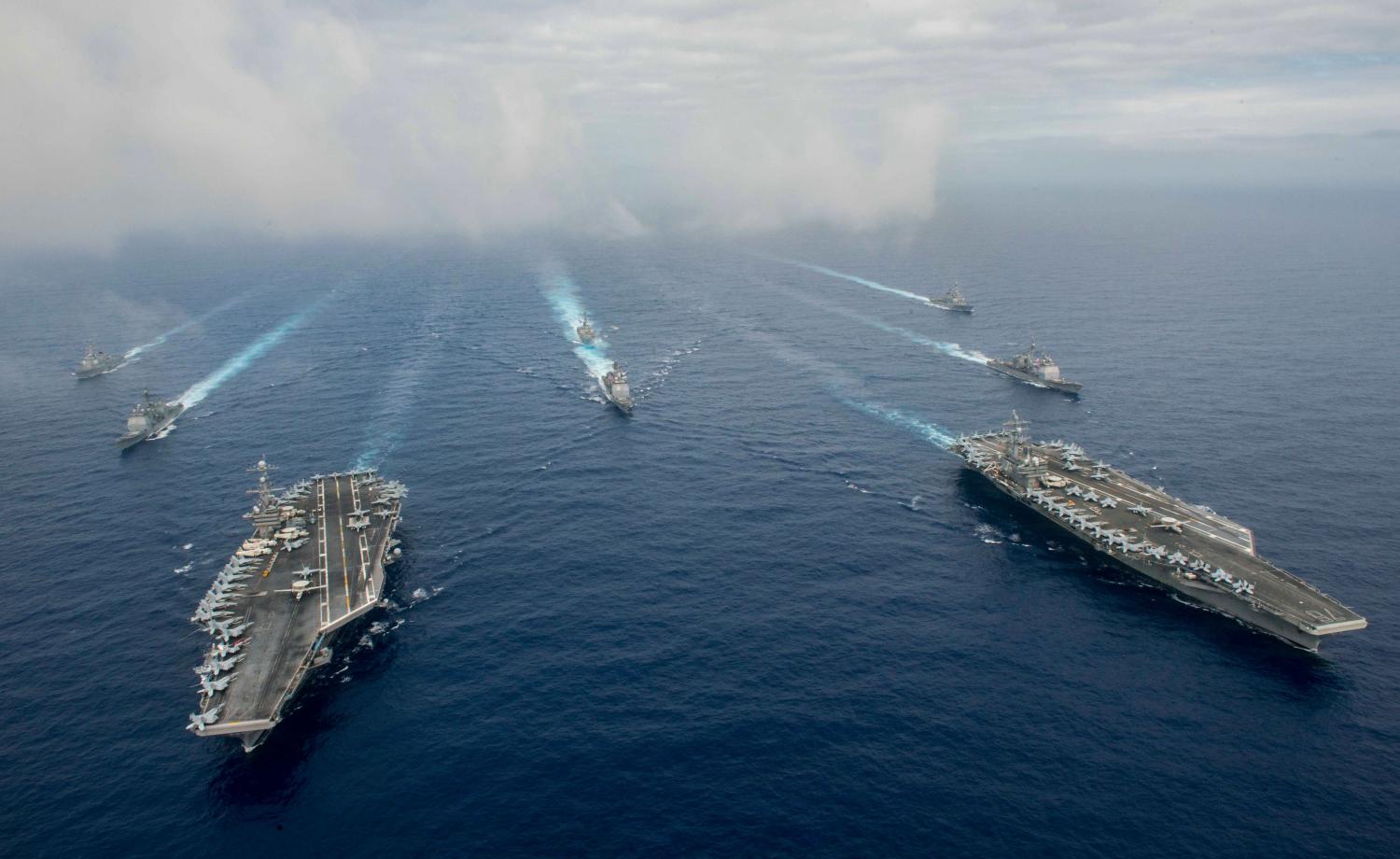 The Nimitz-class aircraft carriers USS John C. Stennis (CVN 74), and USS Ronald Reagan (CVN 76) (R) conduct dual aircraft carrier strike group operations in the U.S. 7th Fleet area of operations in support of security and stability in the Indo-Asia-Pacific in the Philippine Sea on June 18, 2016. Courtesy Jake Greenberg/U.S. Navy/Handout via REUTERS.