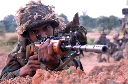 An Indian army Soldier prepares to advance towards a village with U.S. Soldiers from Troop A, 2nd Squadron, 14th Cavalry Regiment ?Strykehorse,? 2nd Stryker Brigade Combat Team, 25th Infantry Division, from Schofield Barracks, Hawaii during a dismounted patrol conducted by both armies during Exercise Yudh Abyas 09, a bilateral exercise involving the Armies of India and the United States.