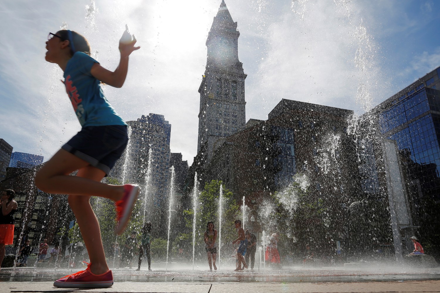 Kids cool off in fountain on the Rose Kennedy Greenway on summer afternoon in Boston