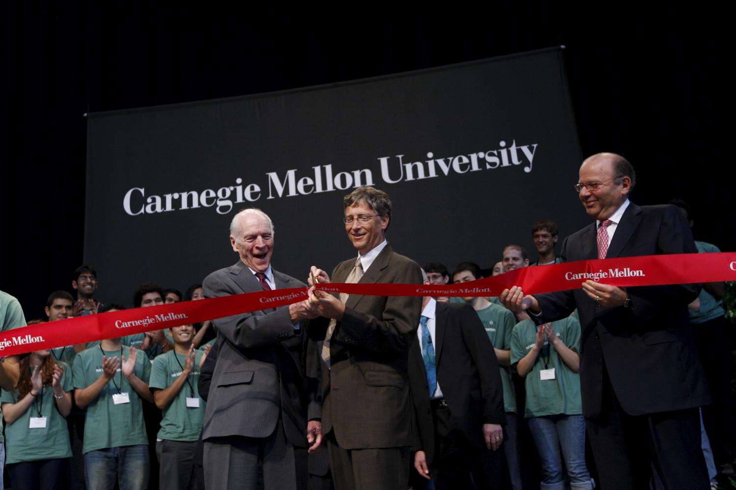 REUTERS/Chris Wattie - Microsoft founder Bill Gates (R) cuts a ribbon with chairman of Hillman Foundation Henry Hillman during a dedication ceremony for the Gates Center for Computer Science and the Hillman Center for Future-Generation Technologies at Carnegie Mellon University in Pittsburgh, Pennsylvania September 22, 2009.