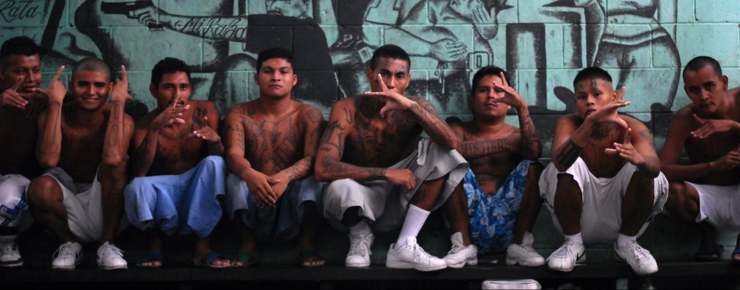 Gang members who are also inmates pose for a photograph at a prison in Quezaltepeque, on the outskirts of San Salvador June 2, 2012. The relentless tit-for-tat murders between El Salvador's two largest street gangs - "Calle 18" and "Mara Salvatrucha" - made the country the most murderous in the world last year after neighboring Honduras, also ravaged by gang violence. That was until Garcia, from the Calle 18 ("18th Street") gang, along with elders from the Mara Salvatruchadeclared an unprecedented truce that authorities say has cut the homicide rate in half in just four months. Picture taken June 2, 2012. To match Feature SALVADOR-GANGS/ REUTERS/Ulises Rodriguez (EL SALVADOR - Tags: CRIME LAW CIVIL UNREST) - RTR34YC6