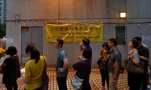 Voters line up outside a polling station in Hong Kong