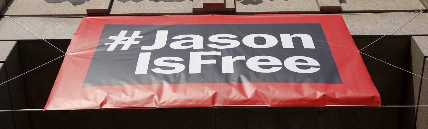 A #JasonisFree banner hangs from the entrance of the Washington Post during the grand opening of the paper's newsroom in Washington January 28, 2016. Reporter Jason Rezaian was recently released from 18 months in prison in Iran. REUTERS/Gary Cameron - RTX24GT5
